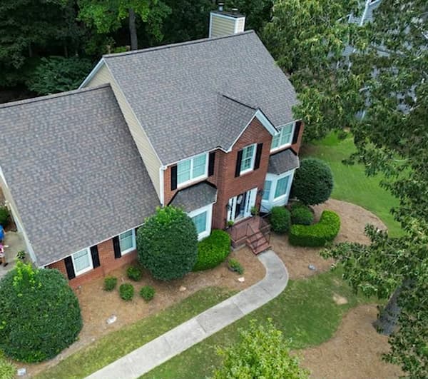 Exterior view of a Pennsylvania colonial home showing roof, chimney, and gutter system